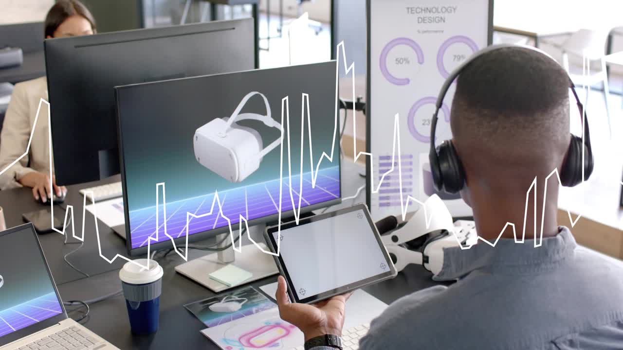 Male designer holding tablet and tapping screen, spiking waveform during VR analytics review