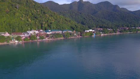 Fantastic-aerial-top-view-flight-Beach-Village-Huts-Resort,-tropical-Bungalows-on-Mountainous-Island-Thailand-2022
