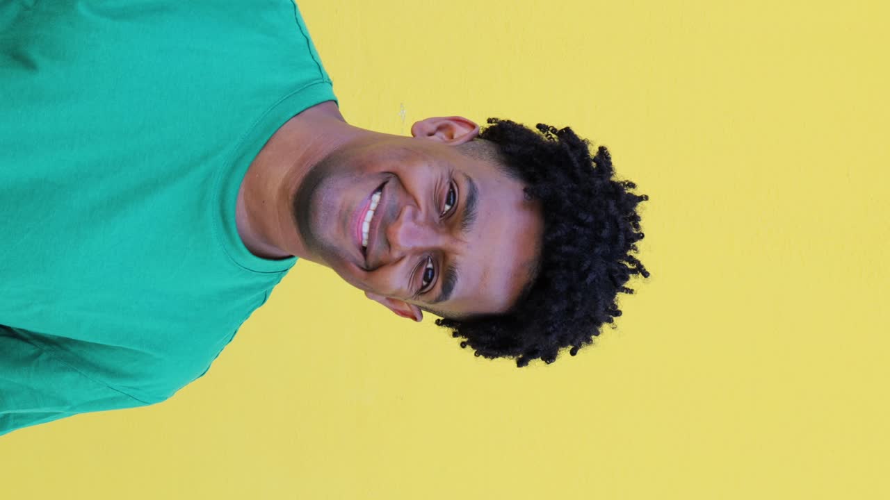 Young positive man raising head and smiling