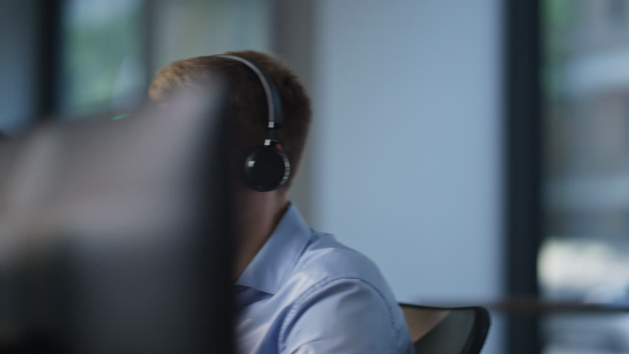 Helpline workers consulting clients talking in headset sitting office closeup