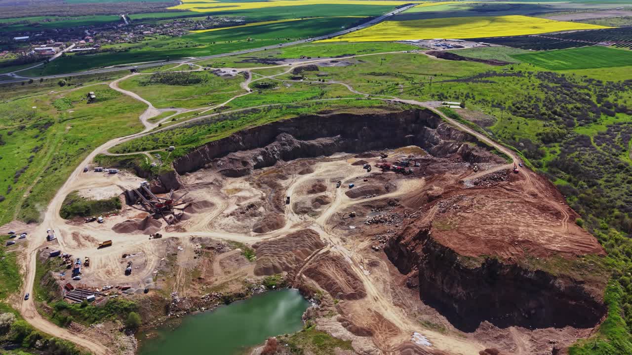 Construction site near highway with vehicles and land clearing activities