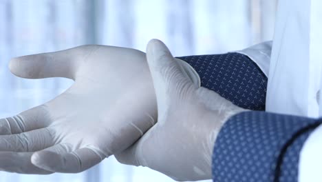 doctor putting on medical gloves