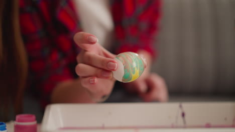 art teacher and little student apply pattern on boiled eggs