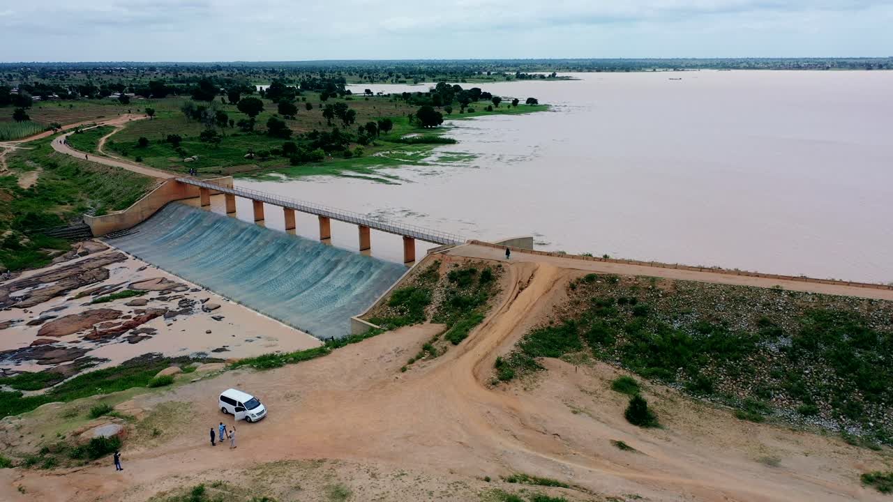 Overflow water runs off the Ajiwa dam in Nigeria's Katsina State - sliding aerial view