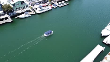 Aerial-View-of-a-Small-Boat-Sailing-in-Harbor---Overhead-Shot