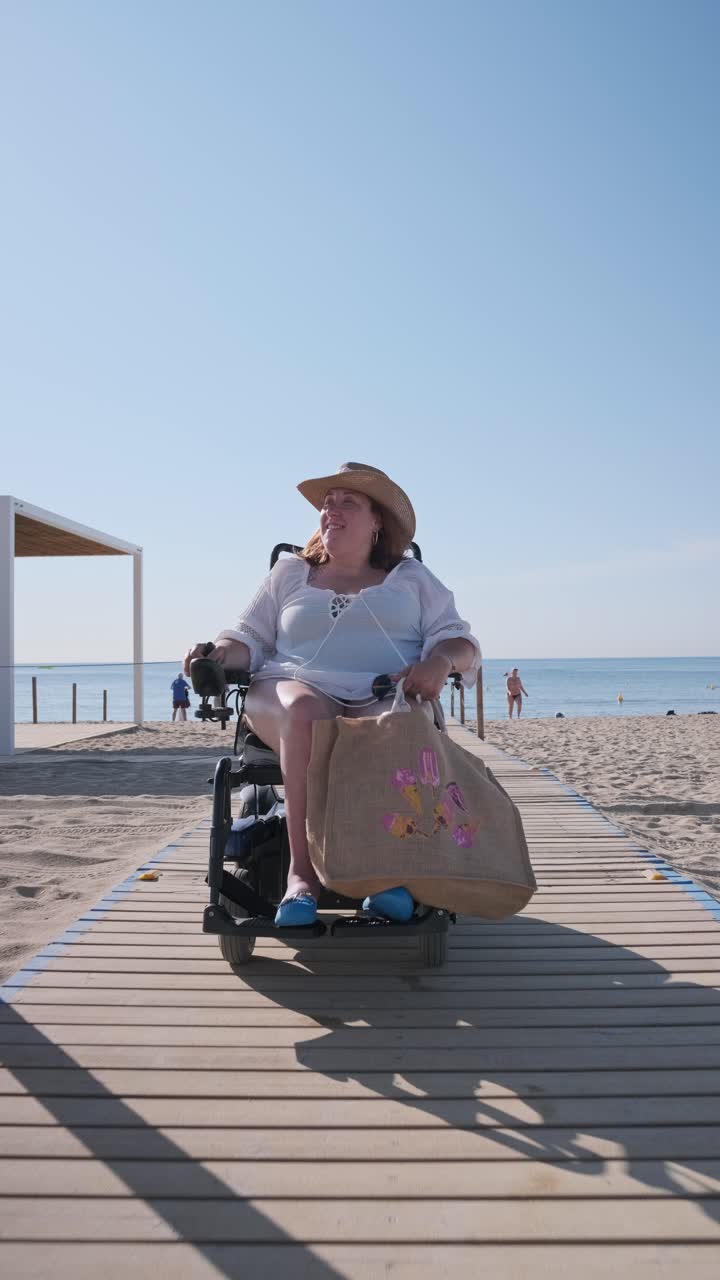 Woman in wheelchair on accessible beach pathway