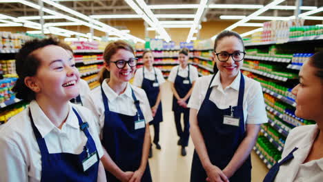 happy team of female retail employees in a supermarket