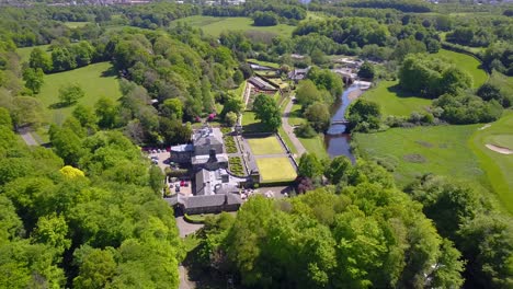 aerial view over pollock house famous country mansion surrounded by vegetation and a river on the countryside of glasgow