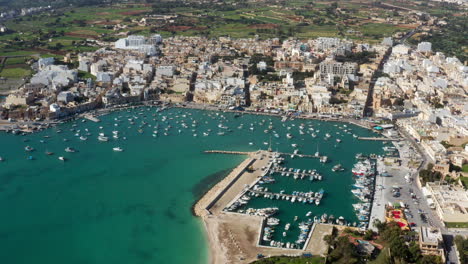 Panoramic-Aerial-View-Of-Marsaxlokk-Harbour-And-Fishing-Village-In-South-Eastern-Malta
