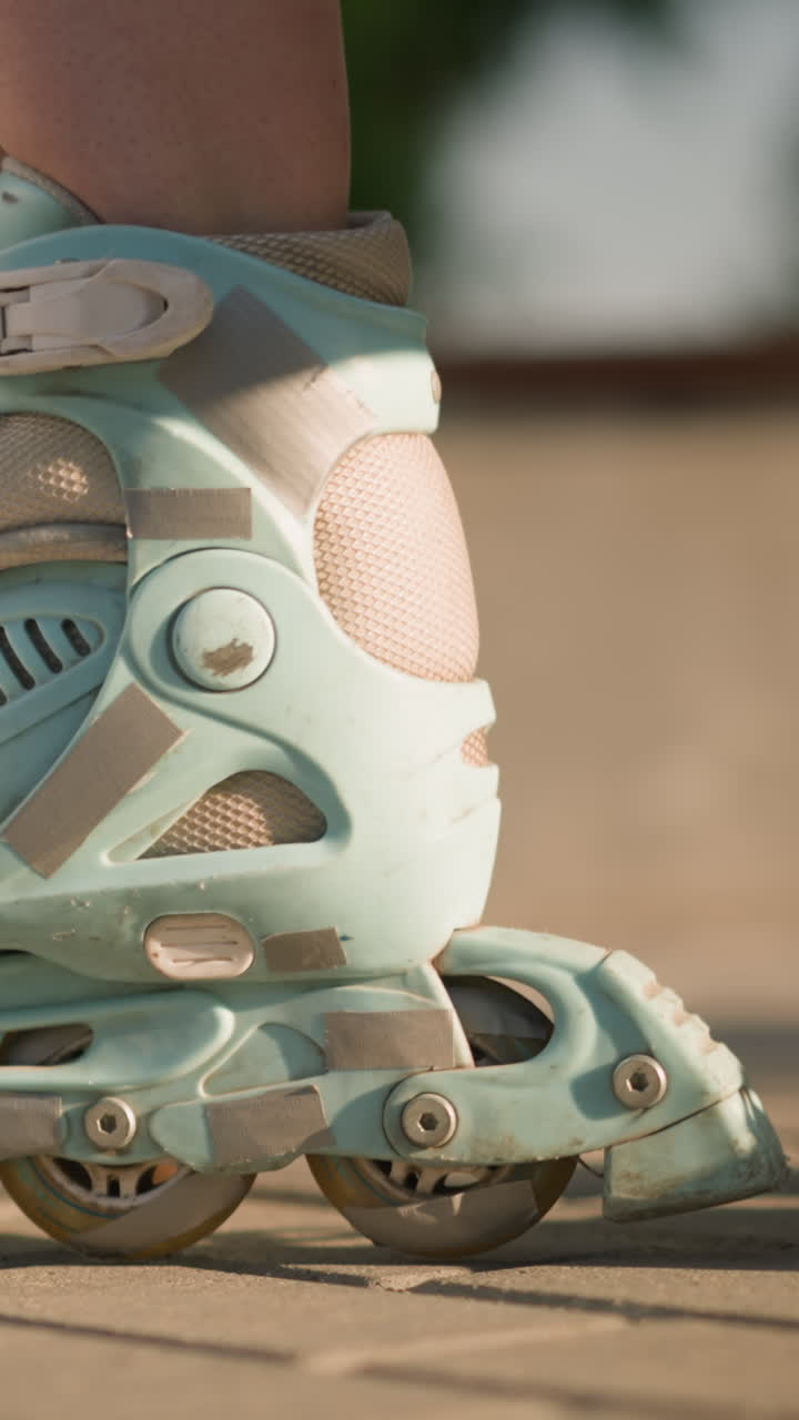 Close-up leg view of individual rolling forward and backward on interlocked ground in roller skates, then gently stamping ground, showcasing fluid movements of roller skating