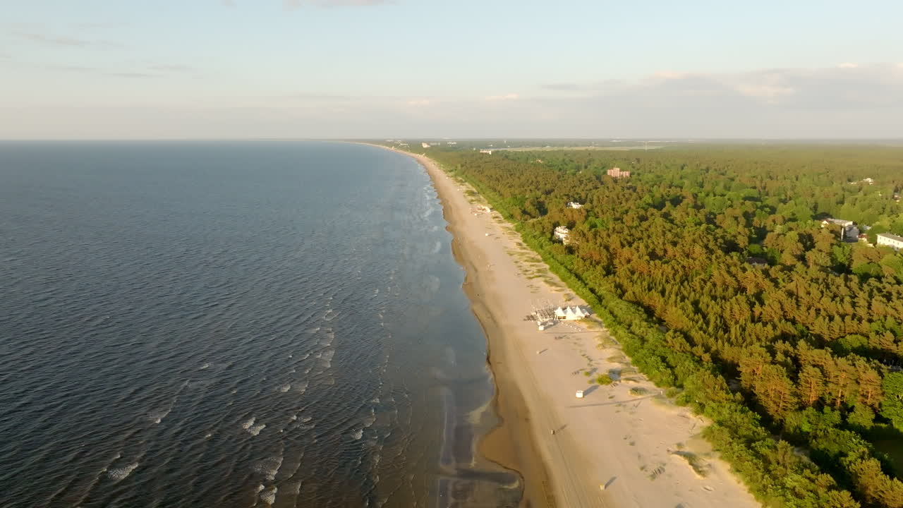 Drone flying backwards over the Jurmala beach, summer evening in Latvia