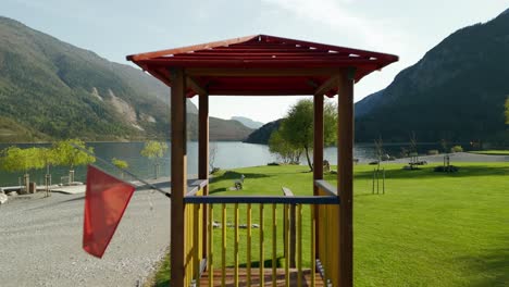 drone passing through wooden tower for lifeguard along shores of molveno lake, trentino alto adige in italy