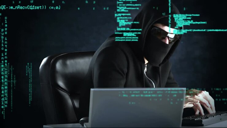 Sneaky hacker working on two computers