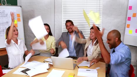 Casual-business-team-throwing-papers-in-the-air