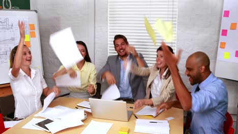 casual business team throwing papers in the air