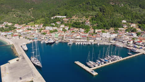 slow panning drone shot of sami port in kefalonia island, greece with ferries docked along the calm ionian harbor