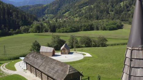 A-drone-shot-of-some-small-wooden-cabin-in-a-valley-of-the-mountain