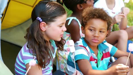 kids having marshmallow candy in tent