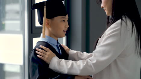 mother touching her son, who is graduating