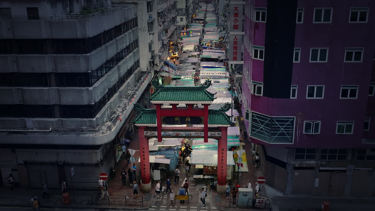 Temple Street market at dusk in Mongkok, Kowloon, Hong Kong, China. Locked mid lens shot