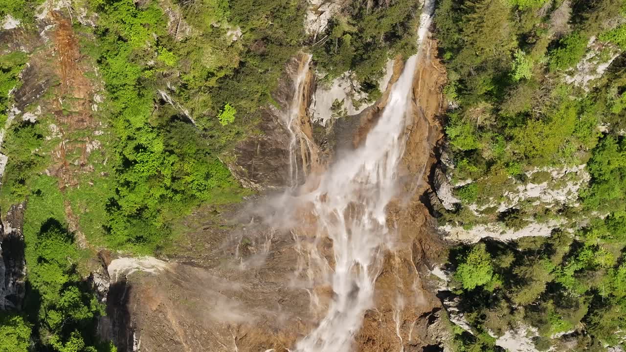 Close-up drone aerial view of Seerenbachfälle waterfall cascading down cliffs in Betlis, Switzerland