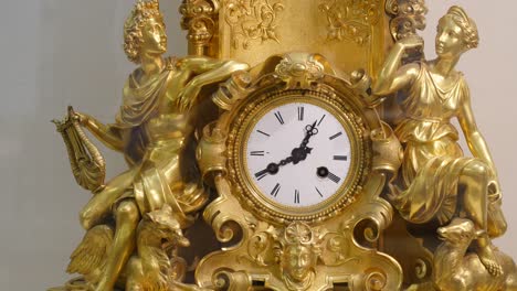 antique gold ornamental clock with classical figures