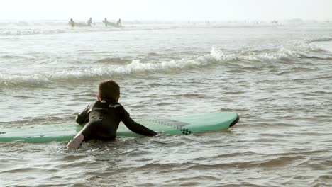 Little-boy-trying-to-surf-on-board