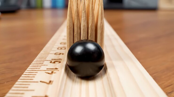Miniature Bowling Game Using Toothpick Pins and a Wooden Ruler