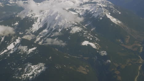 Snow-covered-mountains-shrouded-by-clouds