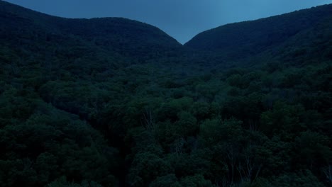 aerial drone video footage of the appalachian mountains after sunset during warm summer nights. this is in new york's hudson valley in the catskill mountain sub-range.