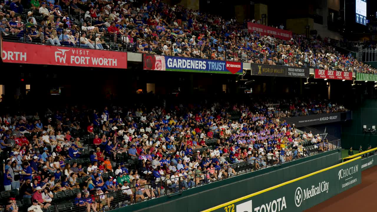 Slow motion landscape of crowd supporters and fans in baseball sports stadium grandstand seating at Arlington Globe Life Field Texas USA America Major League