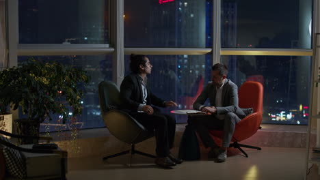 business meeting in modern office at night