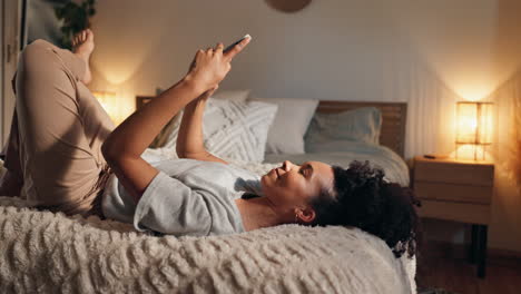 woman relaxing in bed with smartphone