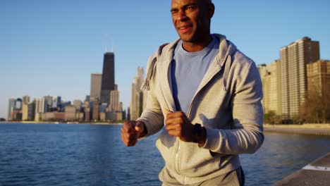 ethnic male in sun flare wearing fitness monitor
