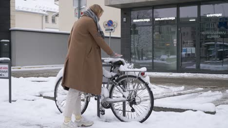 young woman left her bike outside during winter