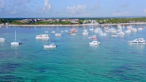 Anchored-boats-floating-on-turquoise-ocean-waters-of-Playa-Bavaro-in-Dominican-Republic