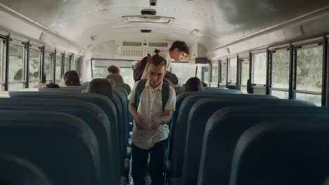 school children taking seats in school bus. teenage pupils boarding on vehicle.