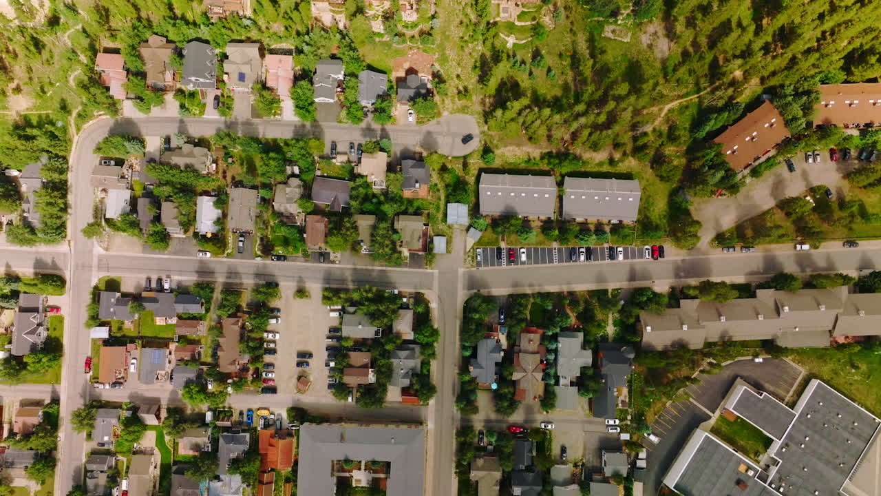Sunlit view of beautiful cozy little town of United States. Drone footage over the nice cottages and roads of a town in Colorado.