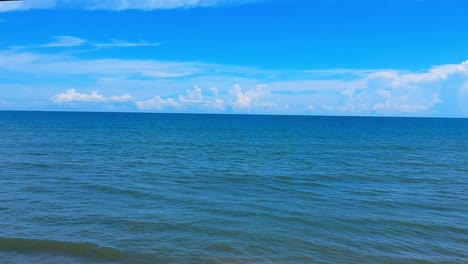 Deep-blue-ocean-and-sky-reveals-waves-and-beach