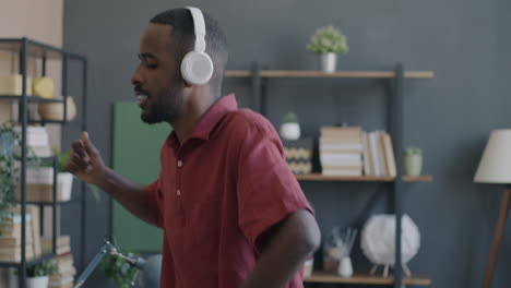 man dancing and singing with headphones