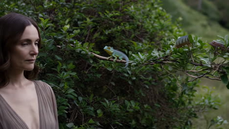 woman in forest gazing at lizard