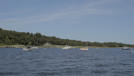 serene and peaceful view of small boats floating in a lake in cape cod