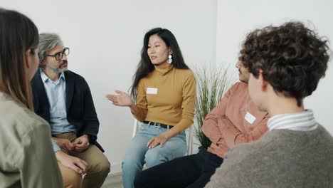 unhappy woman leaving support group meeting then therapist talking to people