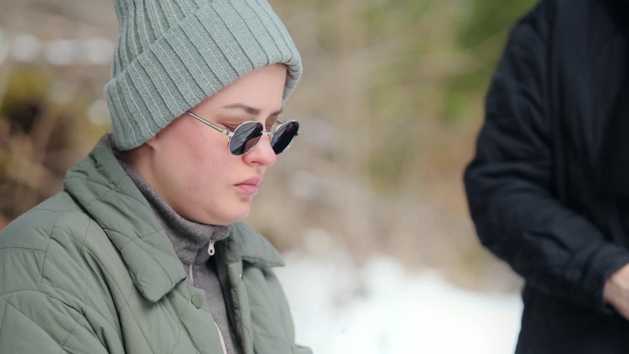 Woman drinking hot beverage in the snow