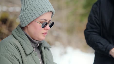 woman drinking hot beverage in the snow