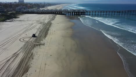 aerial of lifeguard ranger vehicle and abandoned beaches of ventura southern california during covid19