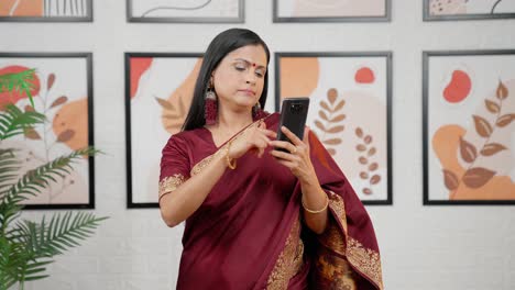 Annoyed-Indian-woman-scrolling-phone