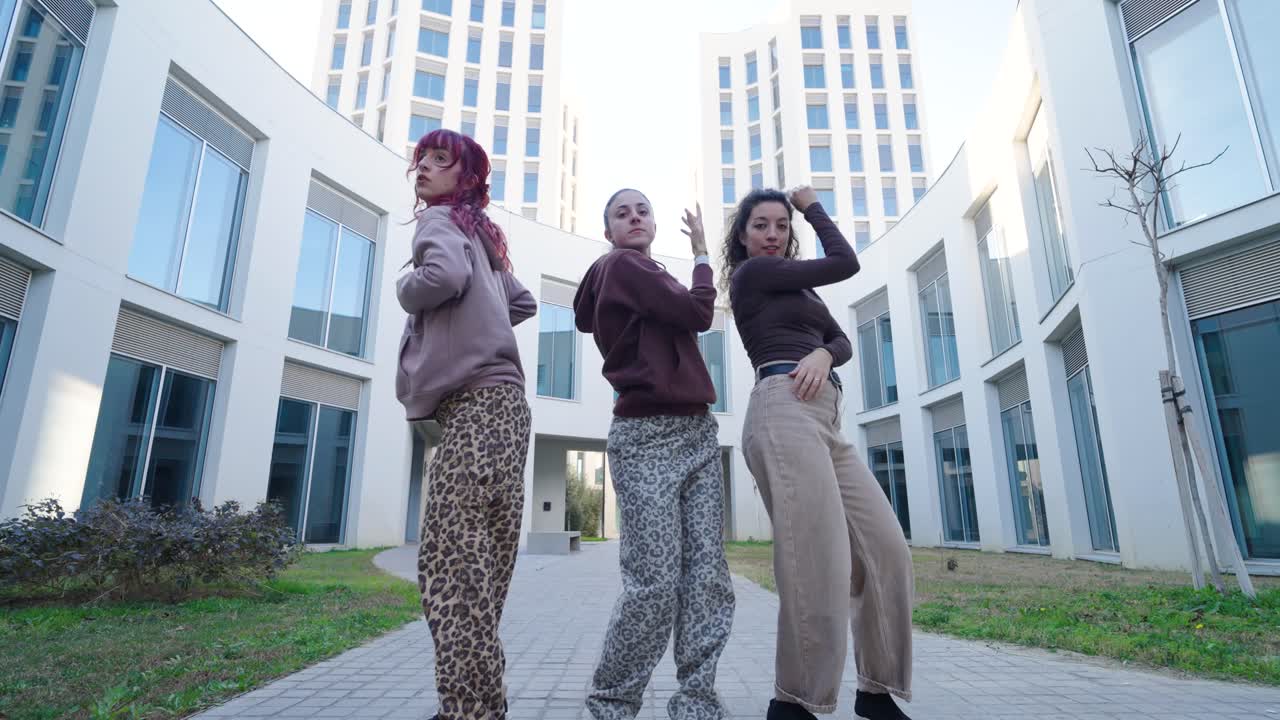 Young women dancing modern choreography outdoors