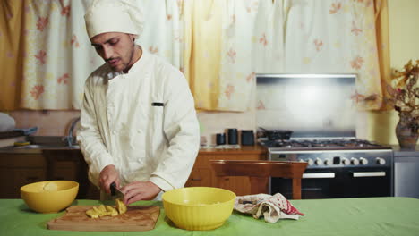 young chef experiments with potato cuts on wooden chopping board.