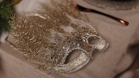 gold glitter venetian mask on festive table setting